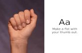 Aa    Make a fist with your thumb out.