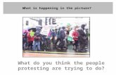 What is happening in the picture? What do you think the people protesting are trying to do?